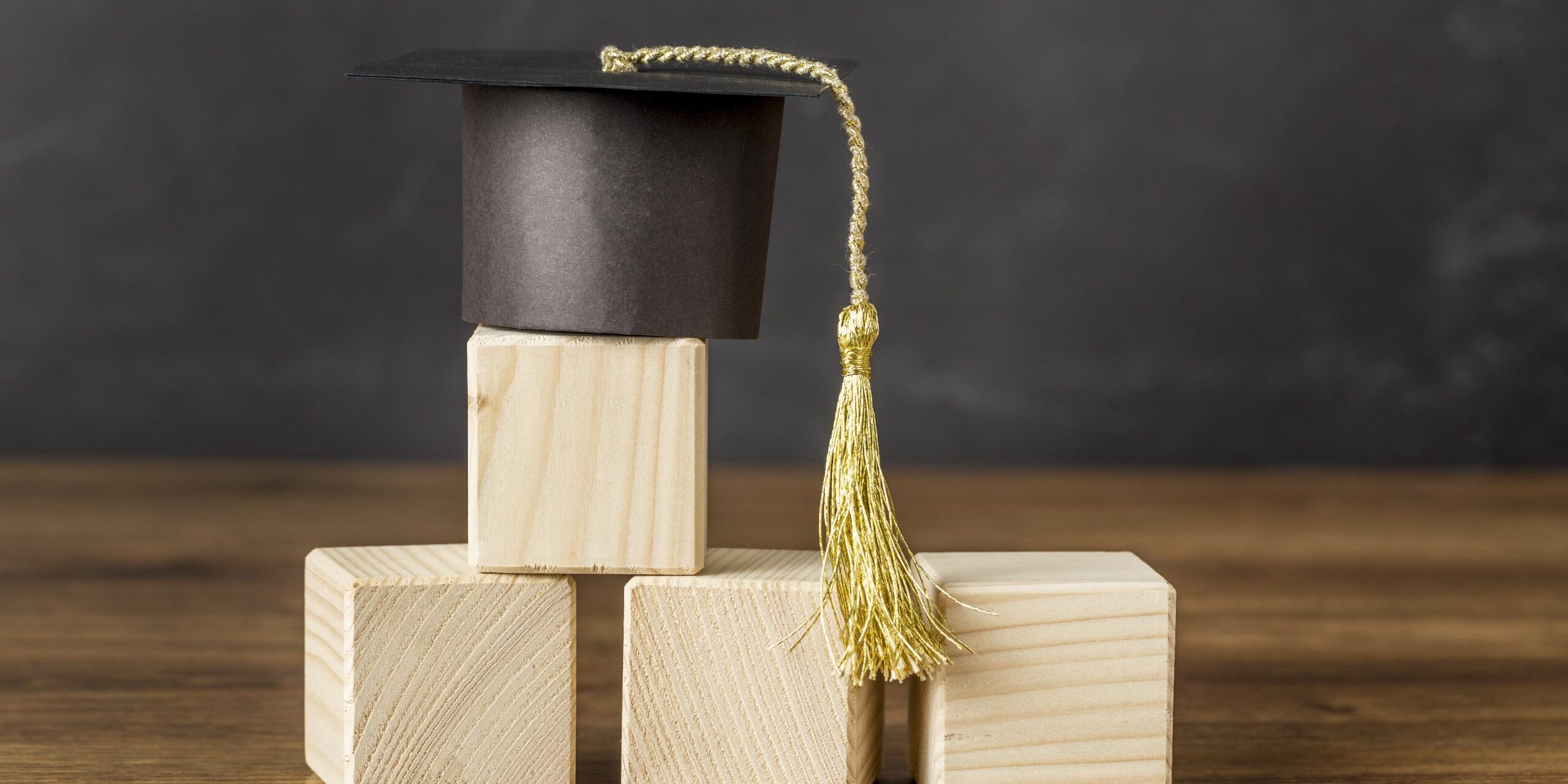 bunch-wooden-cubes-with-graduation-cap